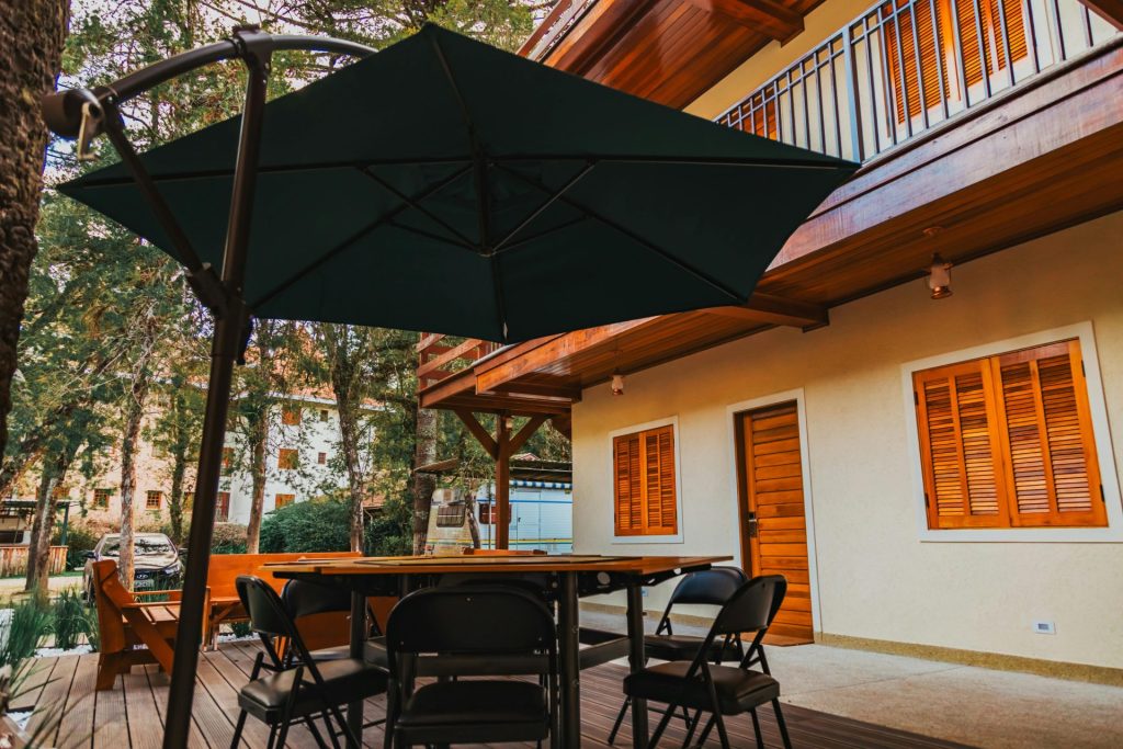 Inviting outdoor patio area with chairs, table, and large umbrella, ideal for relaxation.